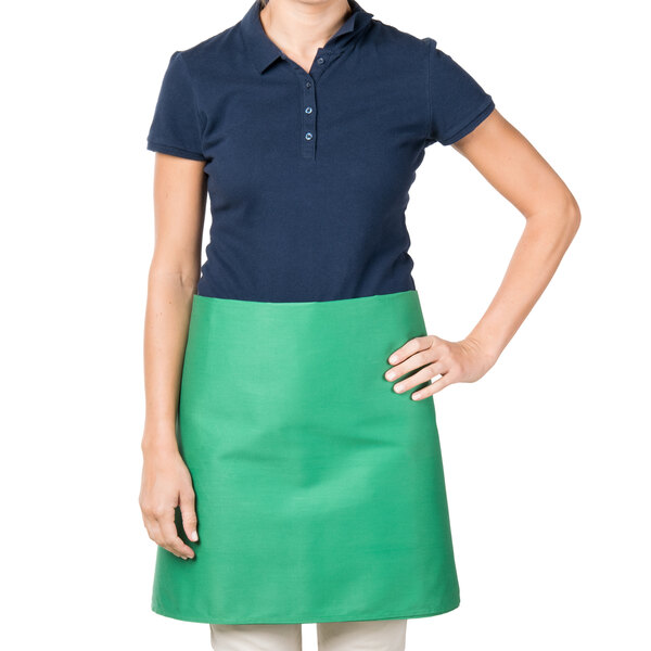 A woman wearing a green Intedge waist apron.