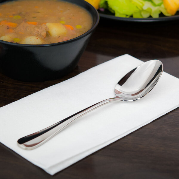 A Libbey stainless steel dessert spoon on a napkin.