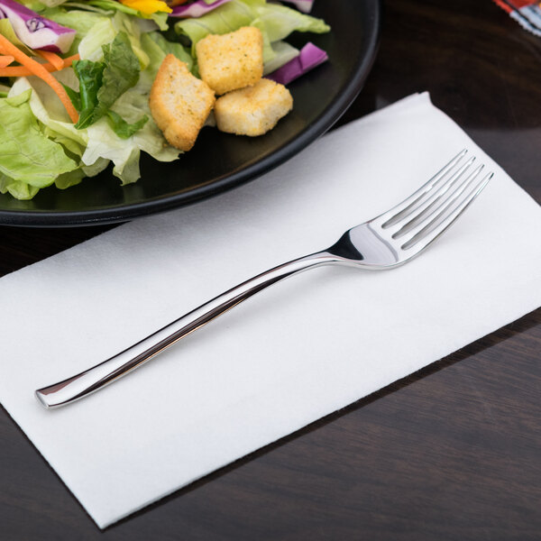A Libbey stainless steel dessert/salad fork on a plate of salad.