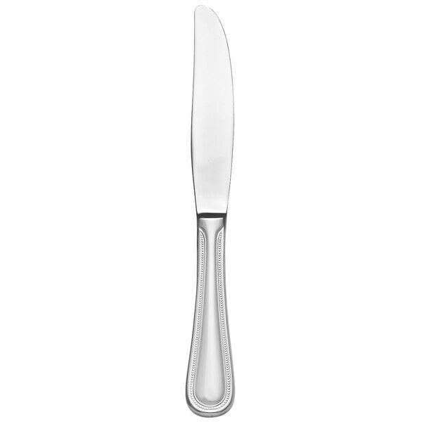 A silver Libbey Calais dessert knife with a serrated blade and pinched bolster.