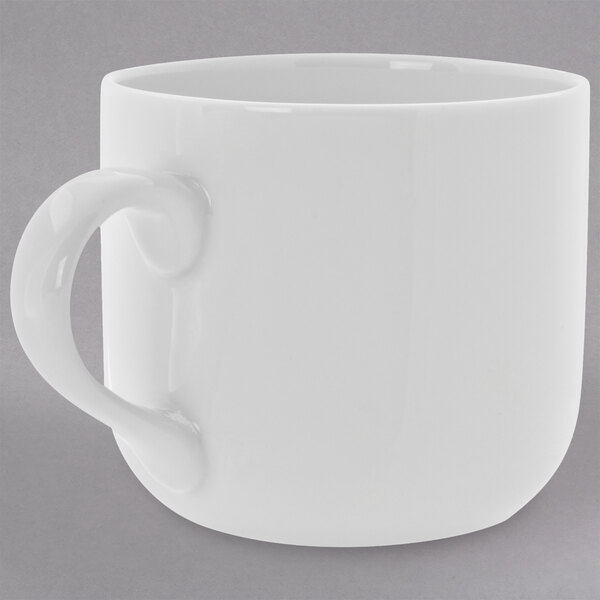 A close-up of a 10 Strawberry Street Royal White round porcelain latte mug with a handle.