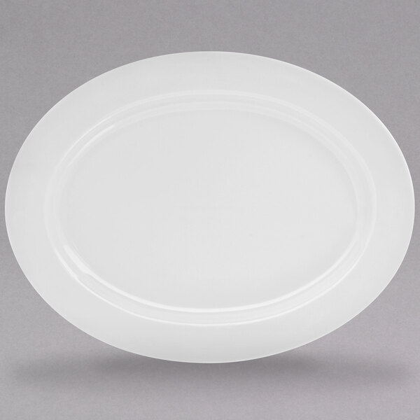 A white porcelain oval platter with a rim.