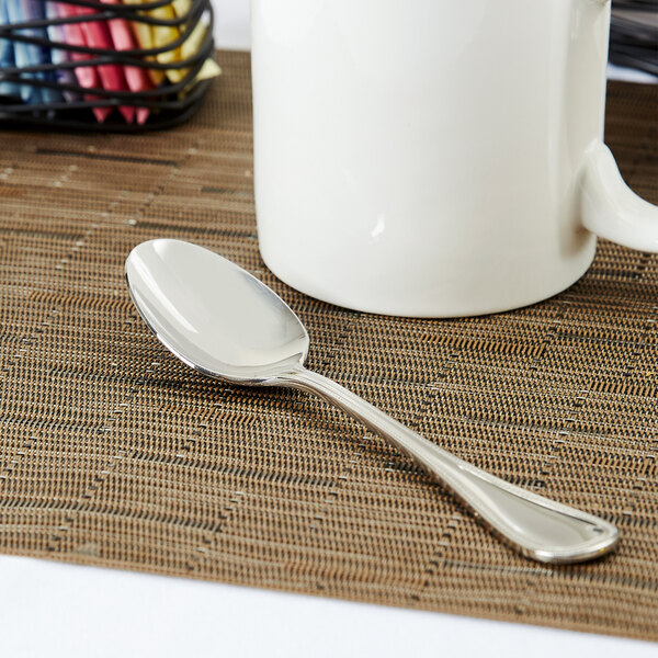 A Libbey stainless steel teaspoon on a placemat.