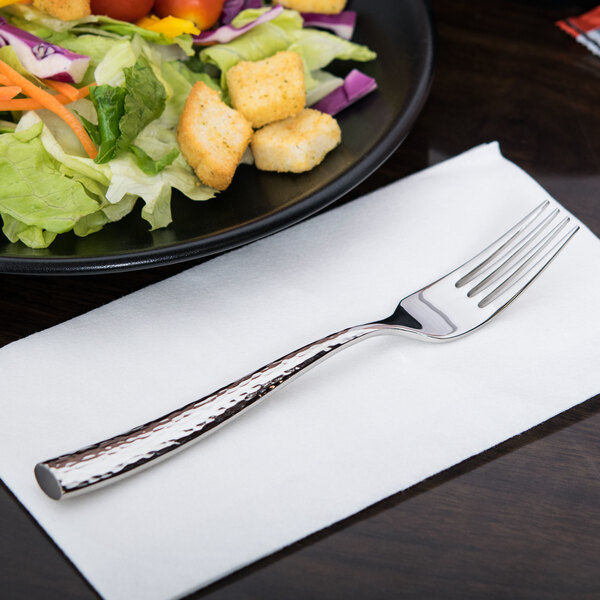 A Libbey stainless steel dessert fork on a plate of salad.