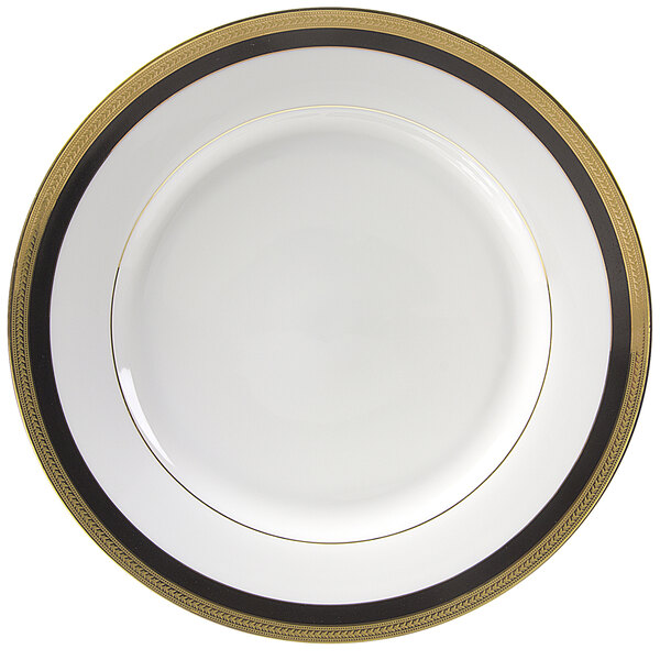 A white porcelain dinner plate with black and gold trim.