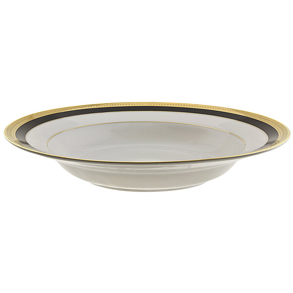 A white bowl with a black and gold striped rim.