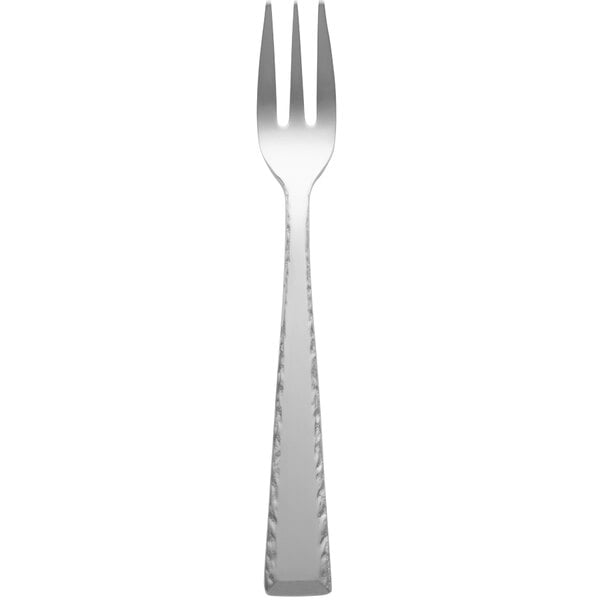A silver Libbey Conde cocktail fork with a white handle.