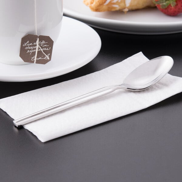 A Libbey stainless steel teaspoon on a napkin.