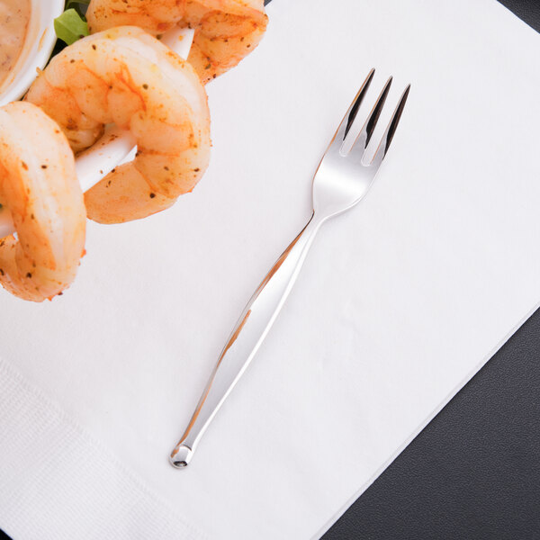 A World Tableware stainless steel mini fork with shrimp on it on a white surface.