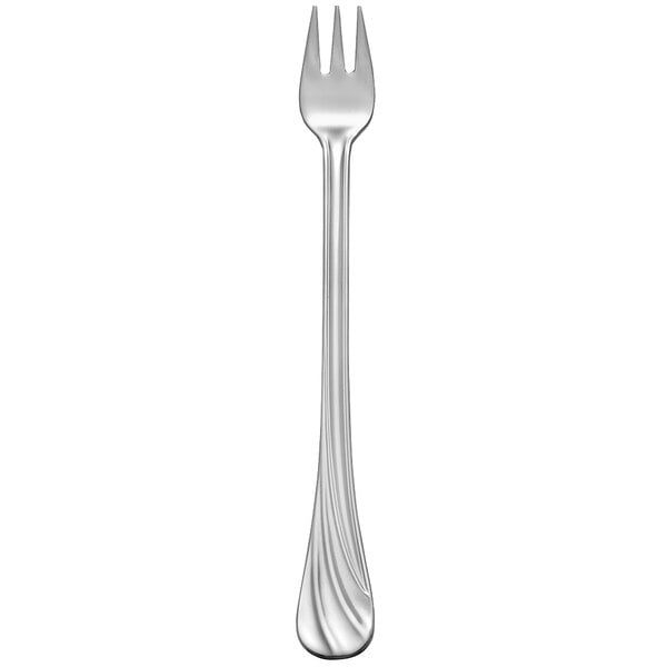 A silver cocktail fork with a white handle.