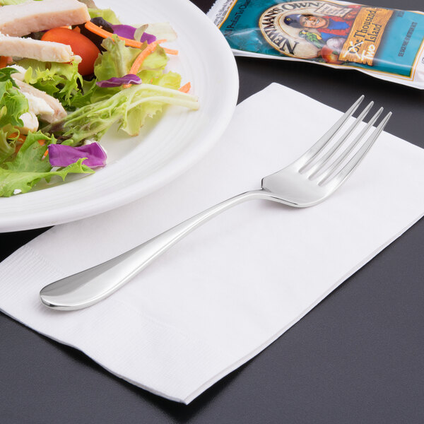 A Reserve by Libbey stainless steel salad fork on a plate of salad.