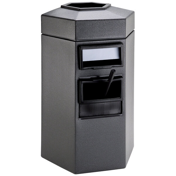 A gray hexagonal trash container with a black lid and a black handle.