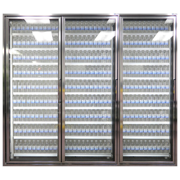 Styleline walk-in cooler doors with shelving and three glass doors filled with many blue bottles of water.