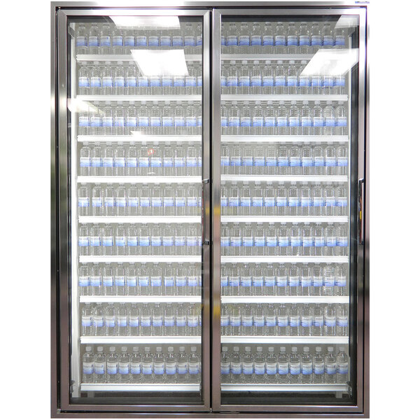 A Styleline walk-in cooler glass door with shelving holding bottles of water.
