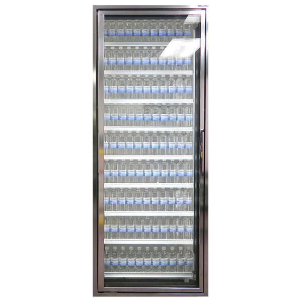 A Styleline walk-in freezer merchandiser door with shelving filled with water bottles with blue labels.