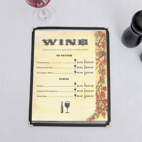 A Mediterranean themed menu on a table with wine glasses.