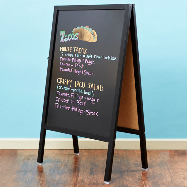 A LARGE BLACK WOODEN PAVEMENT A-BOARD TRADITIONAL CHALKBOARD WITH PAINTED PANELS 
