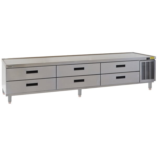 A stainless steel Delfield chef base with drawers.