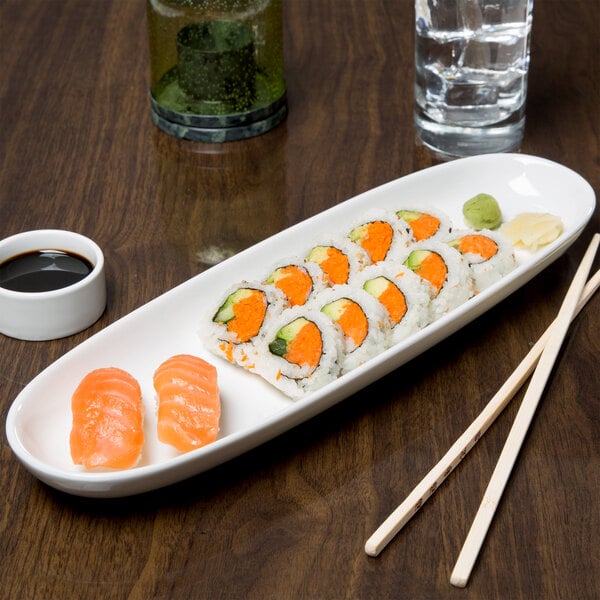 A Libbey white porcelain tray with sushi on a table.