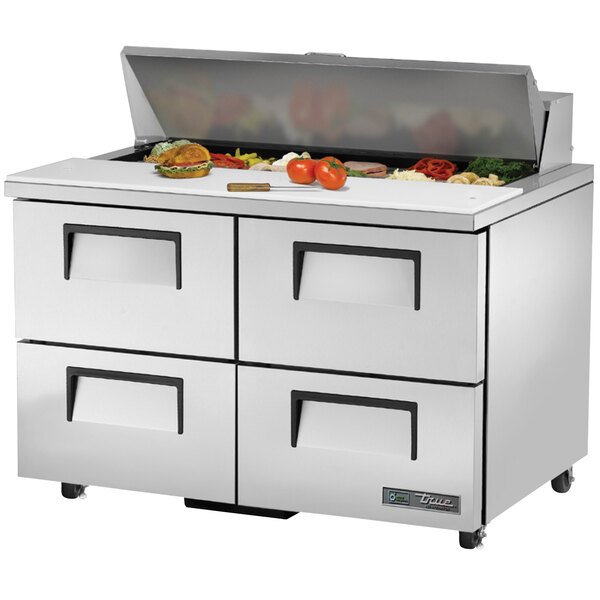 A True refrigerated sandwich prep table with four drawers on a counter.