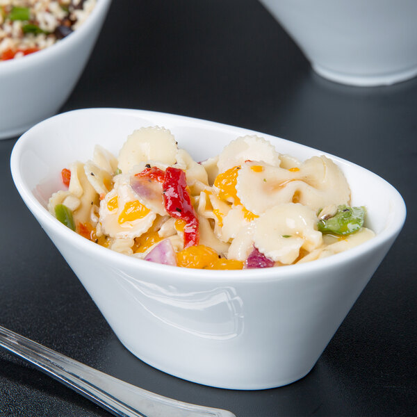 A close up of a white Libbey Neptune bowl filled with pasta and vegetables.