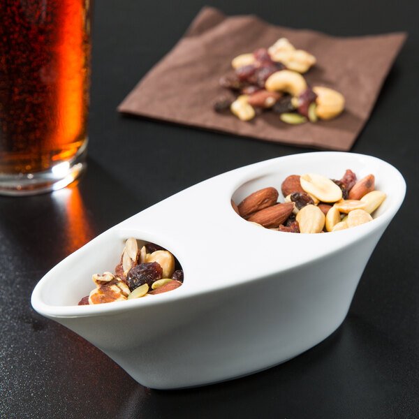 A white Libbey porcelain bowl filled with nuts.