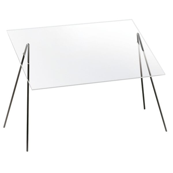 A clear rectangular acrylic sneeze guard with black iron wire frame on a table.