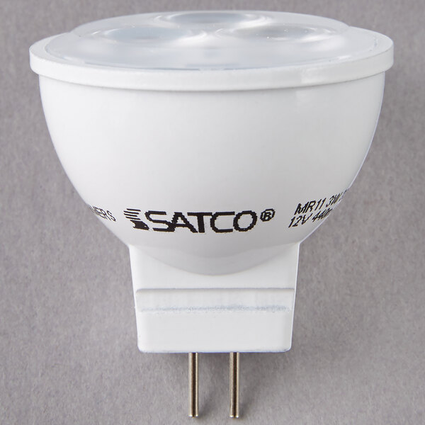 A Satco white LED light bulb with black text on it.