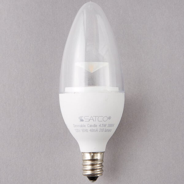 A close-up of a Satco clear LED light bulb with a clear base.