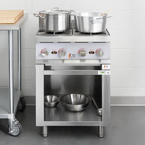 A stainless steel Cooking Performance Group 4 burner range with pots on top.