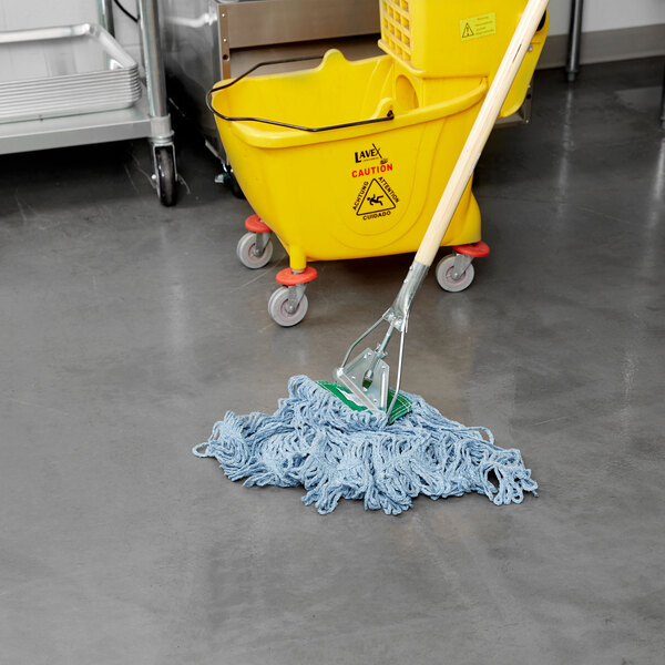 A Rubbermaid blue blend wet mop with a 5" headband in a yellow bucket.
