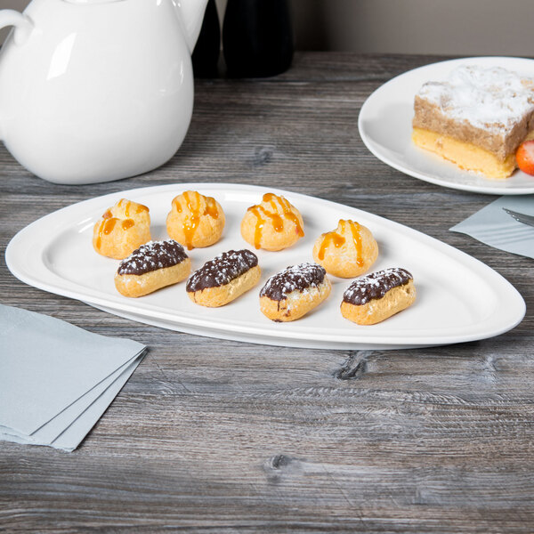A white Libbey Slenda porcelain plate with pastries on a table.