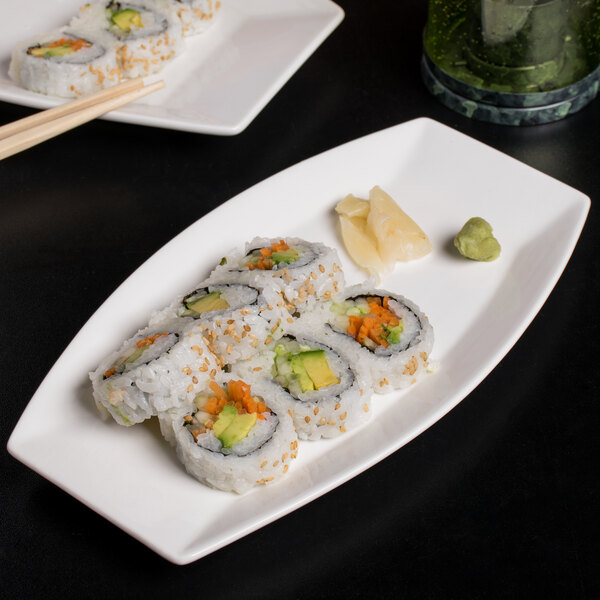 A white porcelain rectangular serving tray with sushi rolls.
