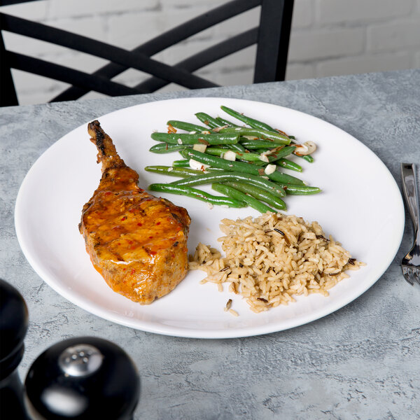 A Libbey white porcelain coupe plate with meat and green beans.