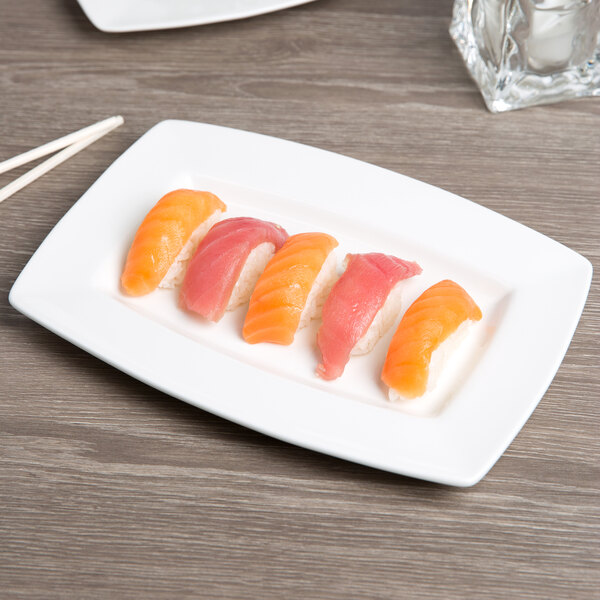 A piece of sushi on a white Libbey rectangular porcelain plate.