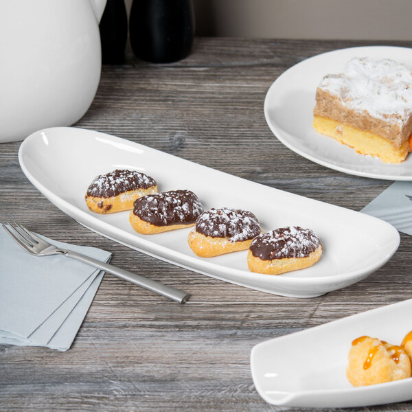 A Libbey white porcelain long plate with pastries on it.