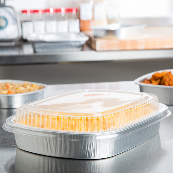 A Durable Packaging aluminum foil pan with food inside on a counter.