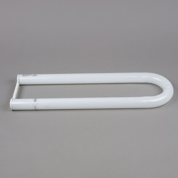 A Satco T12 white U-bend fluorescent light tube on a gray surface.