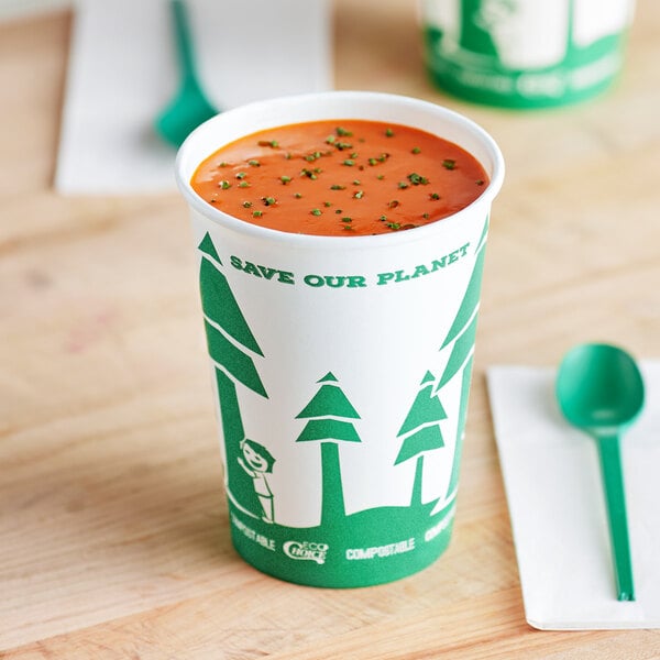 An EcoChoice 32 oz. paper food cup with a tree design filled with soup on a table.