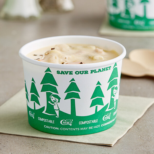 An EcoChoice Compostable Paper Food Cup with a tree design filled with frozen yogurt with a green lid.