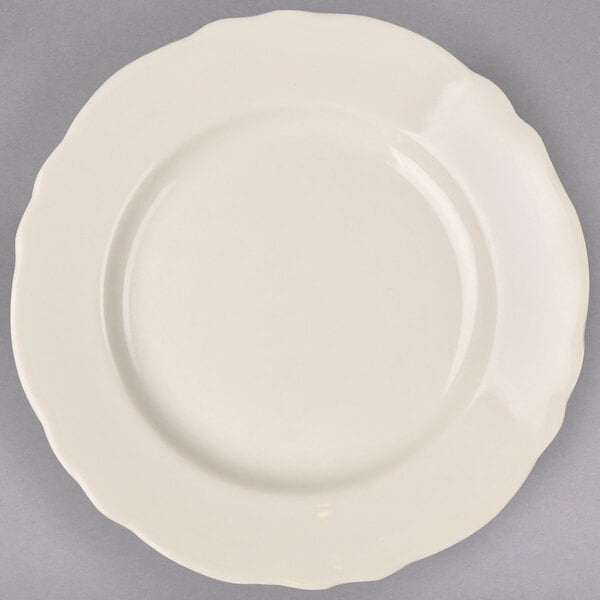 A white Homer Laughlin china plate with a scalloped edge.