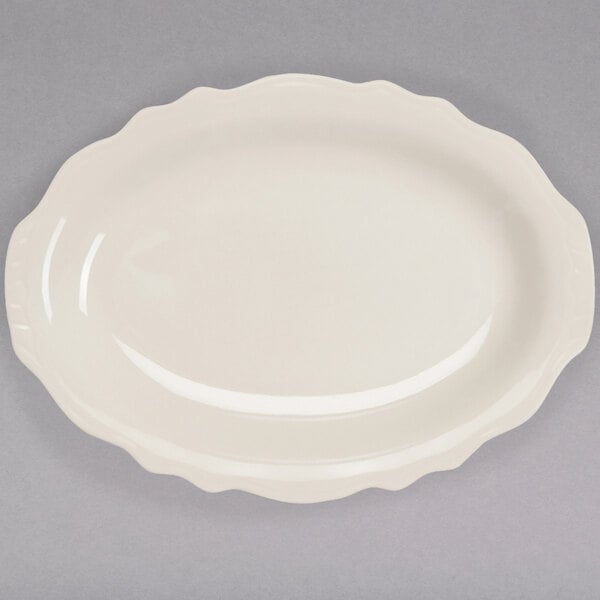 A white oval platter with a scalloped edge.