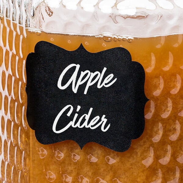 A jar of apple cider with a Choice decorative chalkboard label on it.