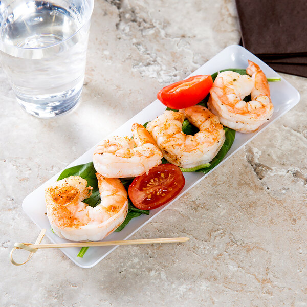 A Fineline Tiny Temptations rectangular plate with shrimp and tomatoes on a table.