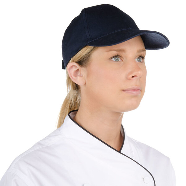 A chef wearing a navy 6-panel cap.