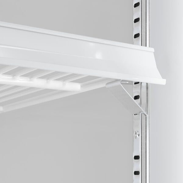 A white shelf with metal brackets inside a black glass door refrigerator.