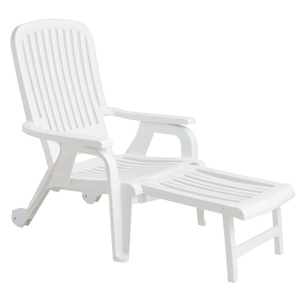 A white Grosfillex resin chair with a pull-out footrest.