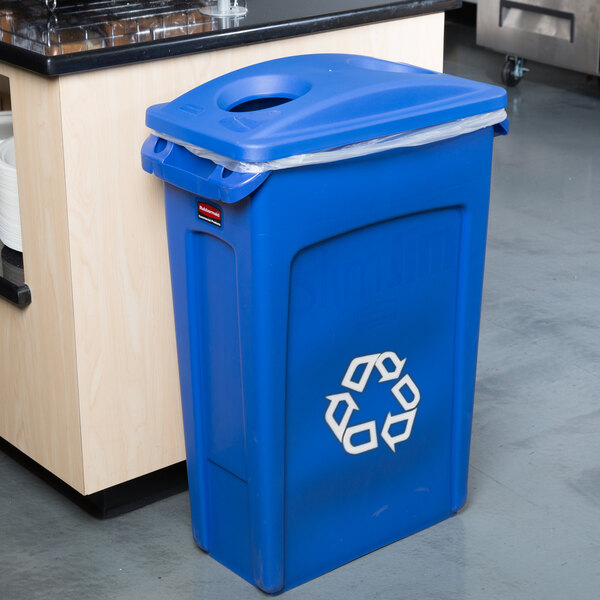 A blue Rubbermaid Slim Jim recycling bin with a white recycle symbol on it.