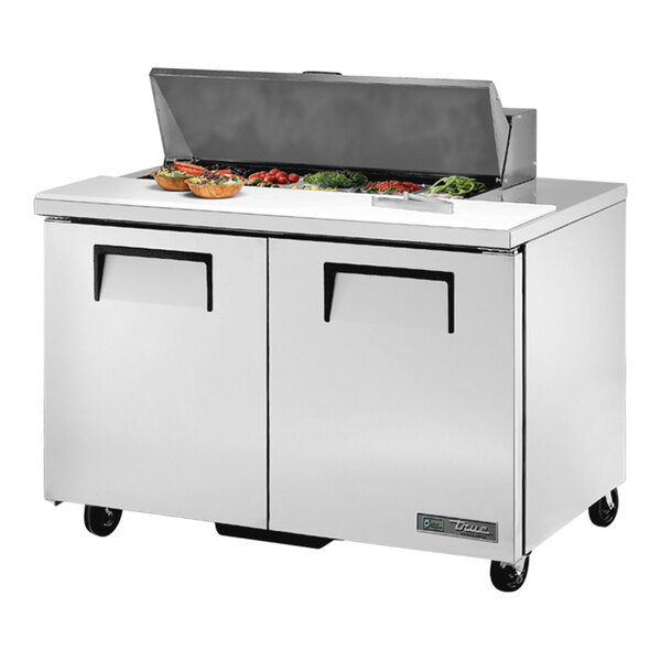 A True commercial refrigerated sandwich prep table with a food on the counter.
