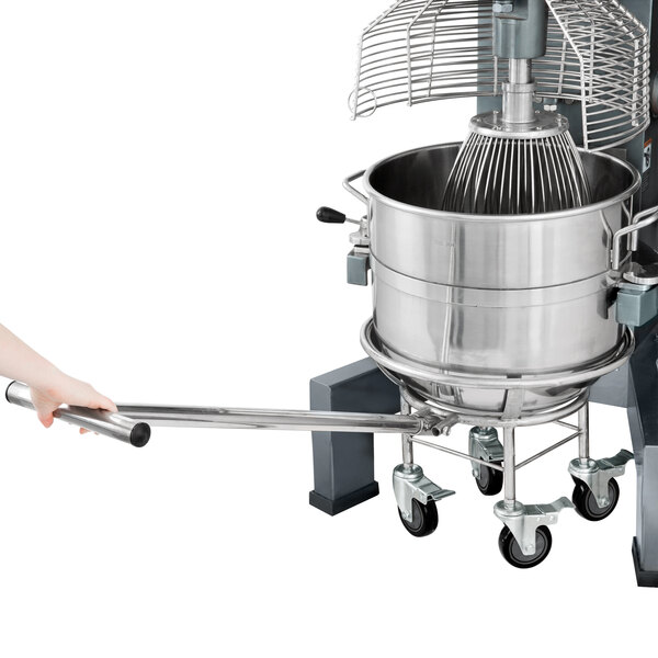 A person using an Avantco bowl truck to carry a large metal mixer bowl.